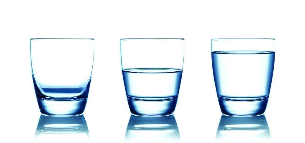 Emptyhalf and full water glasses Isolated on white | Catholic Charities of Central Colorado